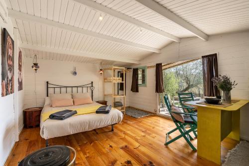 a bedroom with a bed and a table and chairs at Cabaña Shadú in Lanjarón