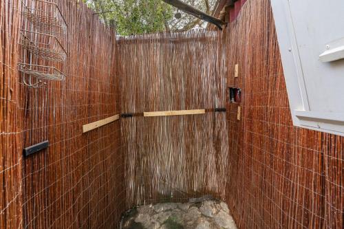 a shower with a wooden fence in a bathroom at Cabaña Shadú in Lanjarón