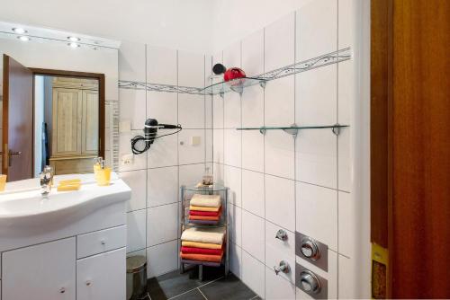 a bathroom with a sink and a towel rack at Der Falkenhorst in Bad Sachsa