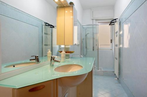 a bathroom with a sink and a shower at Zaffiro Apartment With Garage in Rapallo