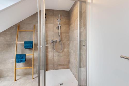 a bathroom with a shower with blue towels at kleine Auszeit in Albbruck