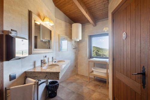 a bathroom with a sink and a toilet at Torigues in Santa María de Oló