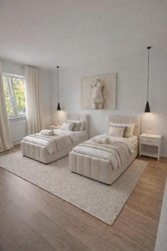 two beds in a white room with white furniture at Zentral mit Gartentraum 3 Schlafzimmer 8 Personen in Paderborn