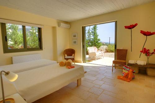 a bedroom with a bed and a view of a patio at Villa Litorina Ideales Resort in Kefallonia