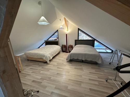 a attic bedroom with two beds and a staircase at Villa julia in Cros