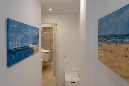 a bathroom with a painting hanging on a wall at Modern Apartment next the Beach in Marbella