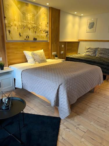 a bedroom with a large bed and a table at Apartments Neckarsulm in Neckarsulm