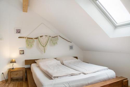 a bedroom with a white bed in a attic at Christines Ferienwohnung in Eitting