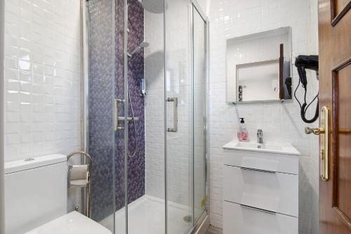 a bathroom with a shower and a toilet and a sink at Apartamento Nº6 - Sunset in Olhão