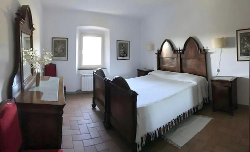 a bedroom with a large bed and a window at La Casa Rossa 2 in Bibbona