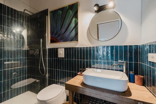 a bathroom with a sink and a toilet and a mirror at Casa Mauro e Roberta Zingaro in Castellammare del Golfo