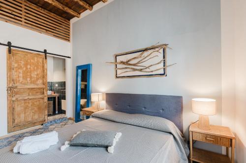 a bedroom with a bed and a large window at Casa Mauro e Roberta Zingaro in Castellammare del Golfo