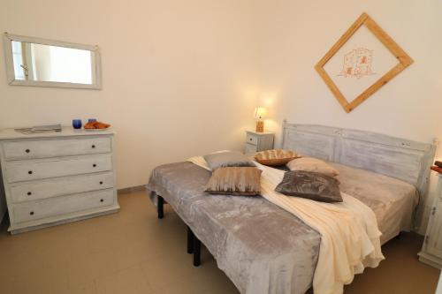 a bedroom with a bed and a dresser at Casa Vacanza Monte Pulciano Otranto in Otranto