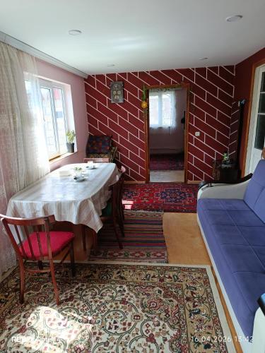 a living room with a table and a couch at Qusar Eniğ kend in Qusar