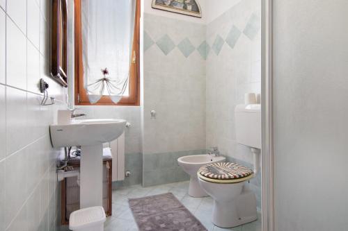 a small bathroom with a sink and a toilet at Colorful Apartment in Colico