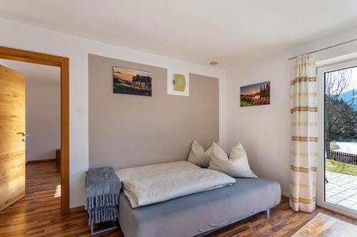 a bed in a room with a window at Bergschatz in Wildschönau