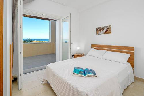 a bedroom with a bed with two books on it at Villa Marconi Apartment 9 in Golfo Aranci