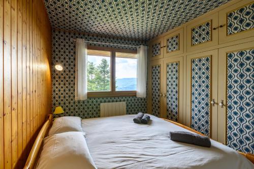 En eller flere senge i et værelse på Chalet Sol La Mi