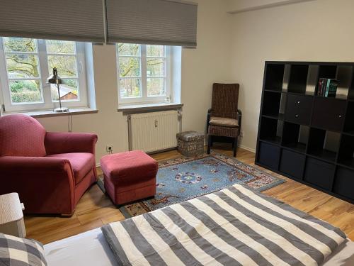 a living room with a couch and a chair at Apartment an der Liitard Kull in Neukirchen-Vluyn