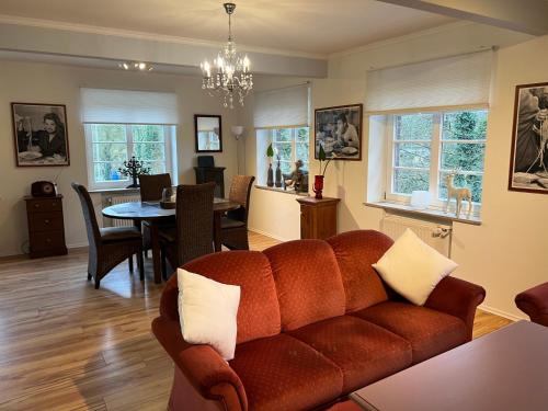 a living room with a couch and a dining room at Apartment an der Liitard Kull in Neukirchen-Vluyn