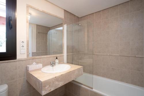a bathroom with a sink and a shower at Duplex apartment Estepona in Estepona