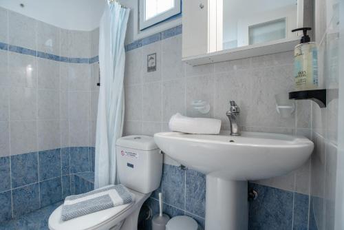 a small bathroom with a sink and a toilet at Galanos Studios Naxos in Naxos Chora
