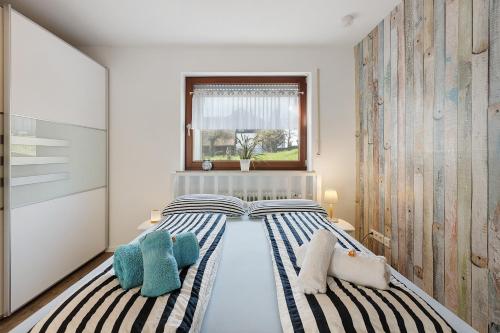 a bedroom with two beds and a window at bleib. Boutique Premium Lake House in Allensbach