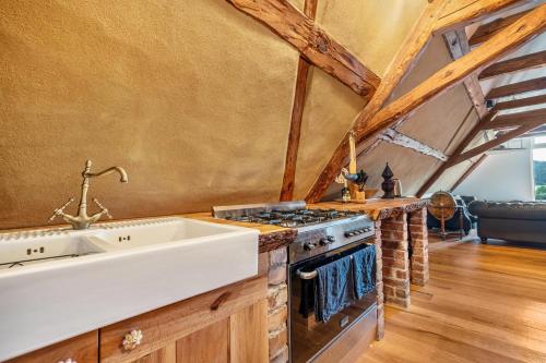 a kitchen with a sink and a stove at Wohlfühlurlaub in der Scheune in Ochsensaal