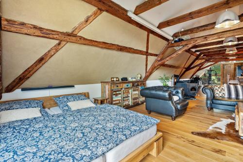 a bedroom with a bed and a chair at Wohlfühlurlaub in der Scheune in Ochsensaal