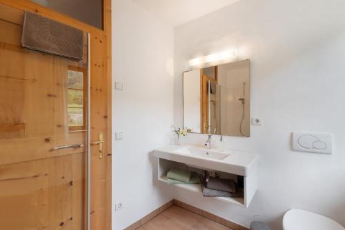a bathroom with a sink and a mirror at Ansitz Baumannhof Apt Erker Suite in Falzes