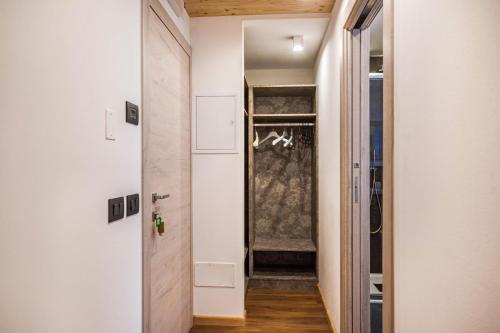 a hallway with a door leading into a room at Chalet Osmar Suite 1 in Campitello di Fassa