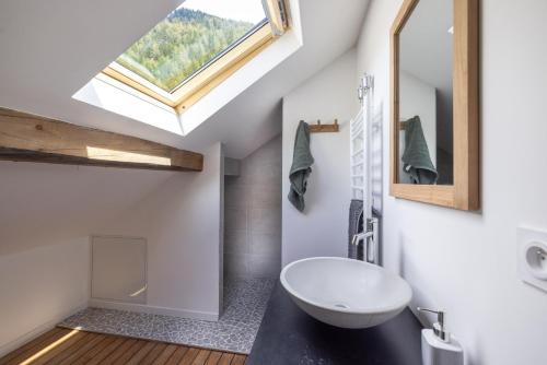 a bathroom with a sink and a skylight at Chalet La Llyre Vallorcine in Vallorcine