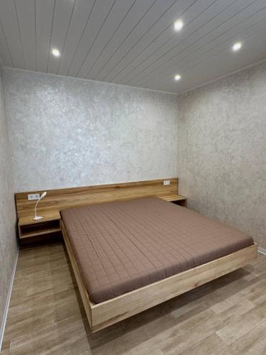 a bedroom with a bed in a room at Harmony Cottage in Kyiv