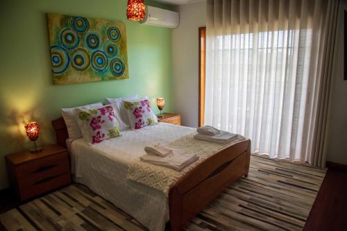 a bedroom with a bed with two towels on it at Recanto Transmontano in Macedo de Cavaleiros
