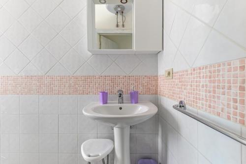 a bathroom with a sink and a toilet at Casa Claudia a Porto Azzurro in Porto Azzurro