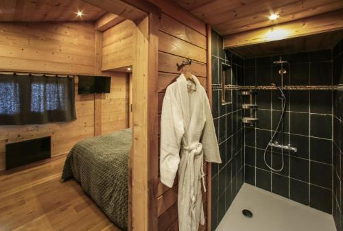 a bathroom with a shower and a bed at Chalet Pesse in Manigod