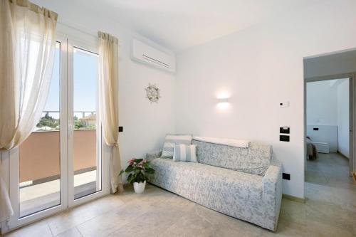 a living room with a couch and a window at Antichi Ricordi - Il Sole in Marina di Andora