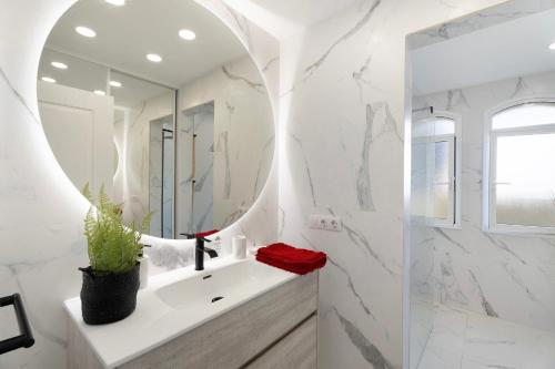 a bathroom with a white sink and a mirror at Villa Romano in Adeje
