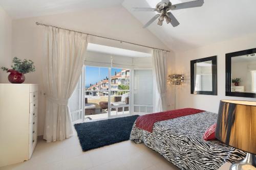 a bedroom with a bed and a window with a view at Villa Romano in Adeje