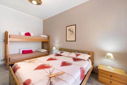 a bedroom with a bed and two bunk beds at Giaely in Borghetto Santo Spirito