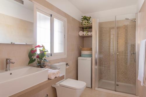 a bathroom with a toilet and a sink and a shower at Ca N'Alicia Des Bosch in Illes Balears
