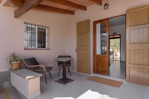 a room with a door and a table and chairs at Ca N'Alicia Des Bosch in Illes Balears