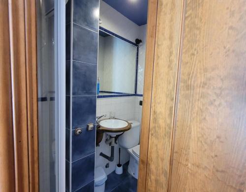 a bathroom with a sink and a toilet and a mirror at El Camino in Molinaseca