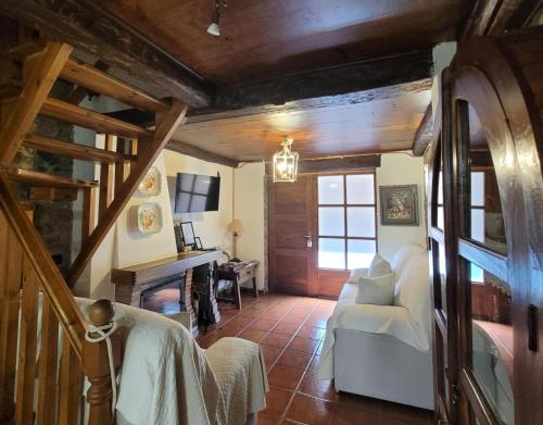 a living room with a white couch and a fireplace at El Camino in Molinaseca