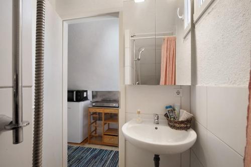 a small bathroom with a sink and a mirror at Ferienwohnung Sila 3 in Weinstadt