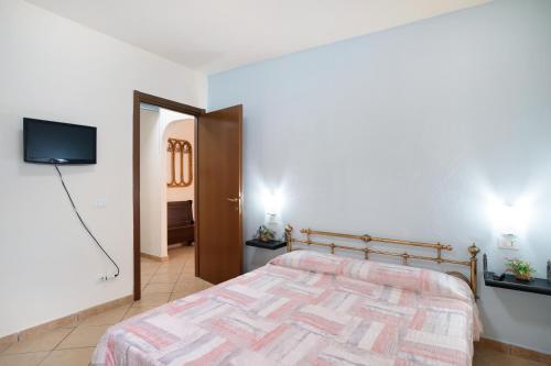 a bedroom with a bed and a flat screen tv at Il Frutteto 48 in Ortovero