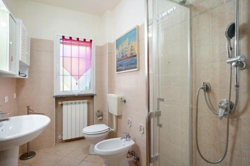 a bathroom with a shower and a toilet and a sink at Il Frutteto 48 in Ortovero