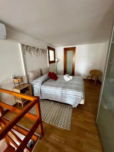a small bedroom with a bed and a couch at Apartments San Biagio in Vicenza