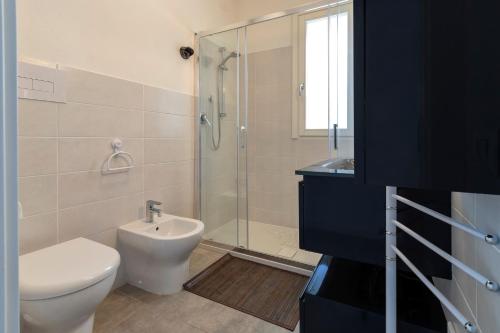 a bathroom with a toilet sink and a shower at Ad occhi aperti - Castelsardo in Castelsardo
