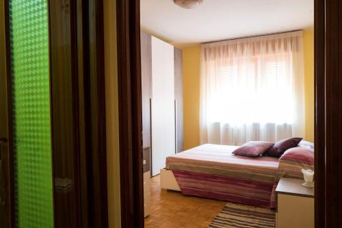 a bedroom with a bed and a window at Casa vacanza Semia in Vinadio